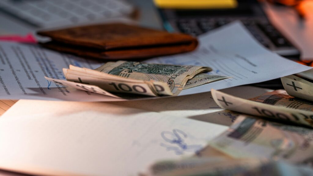 Internationale payroll documenten met bankbiljetten en administratie op bureau tijdens salarisverwerking